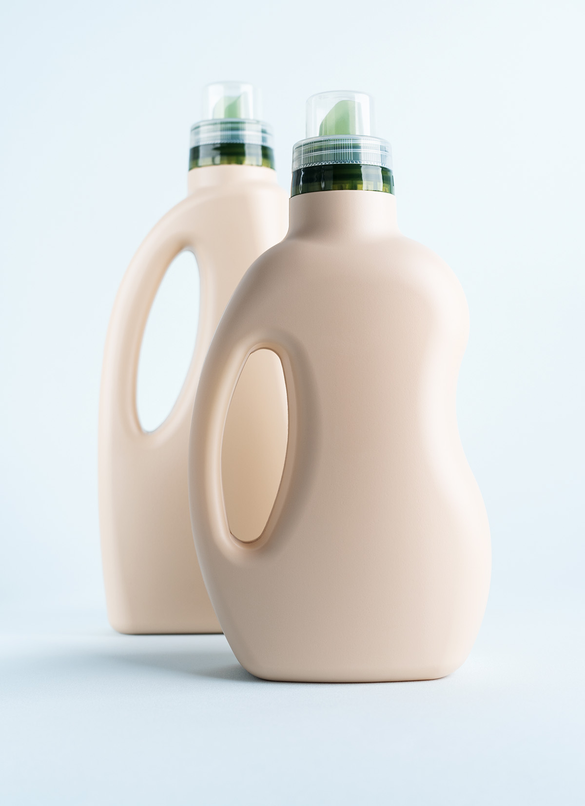 Two tan-coloured cleaning product bottles made from recycled plastic